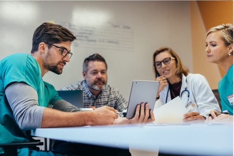 Medical professionals reviewing information together
